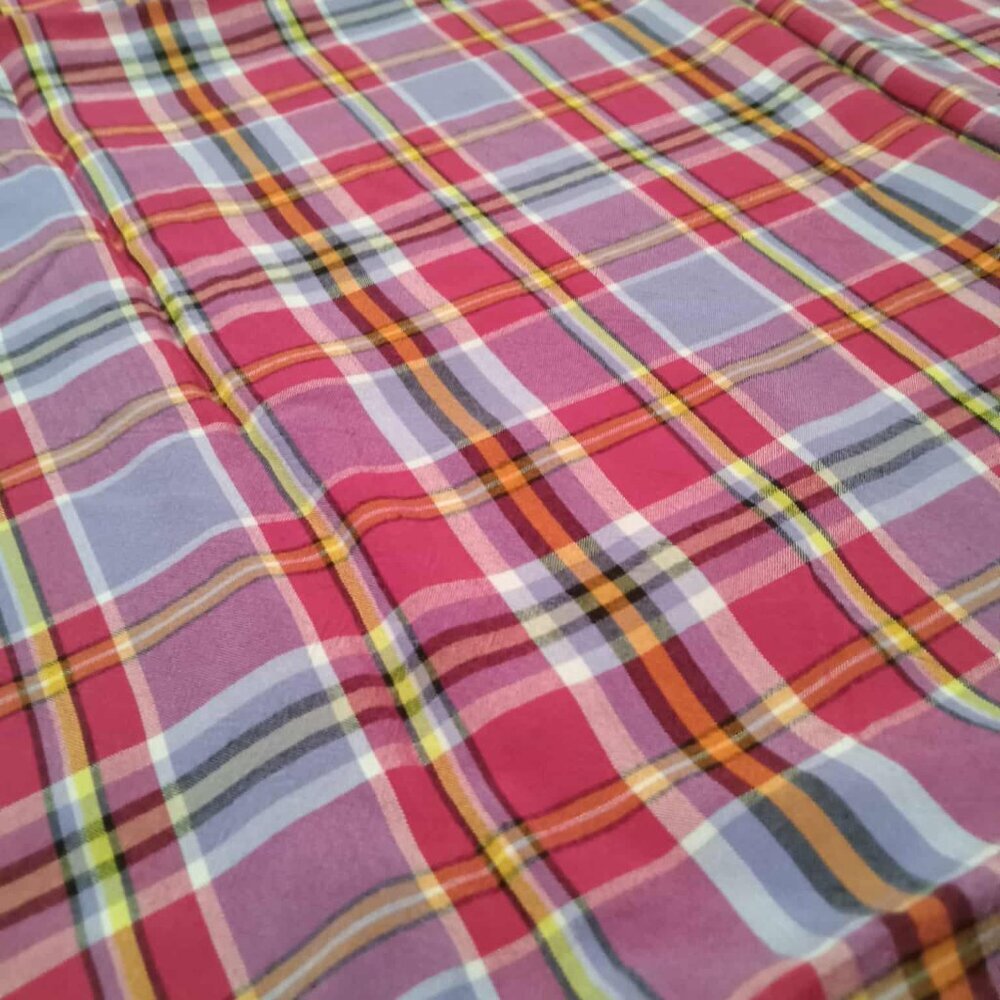 Cotton and linen fabrics in pink and purple checks with touches of
